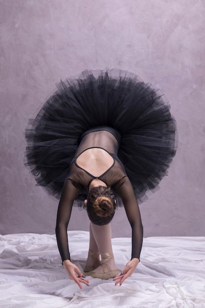 Free photo front view ballerina bending pose