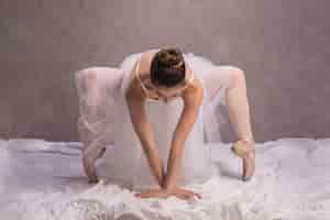 Free photo front view ballerina bending over