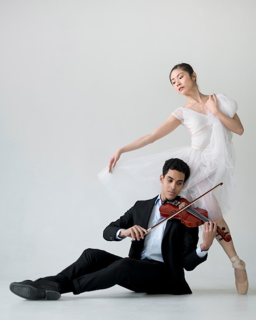 Front view of ballerina and musician playing violing