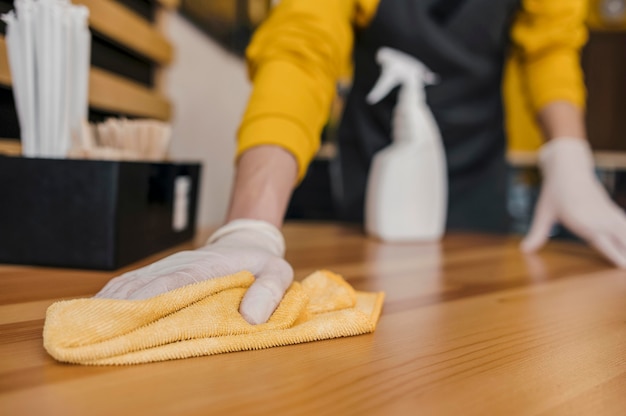 Front view of barista cleaning table