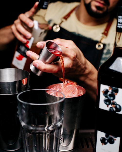 Front view bartender making a drink