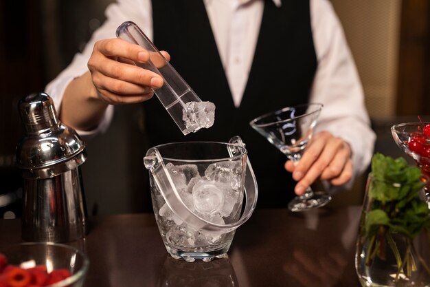 Front view bartender preparing drink