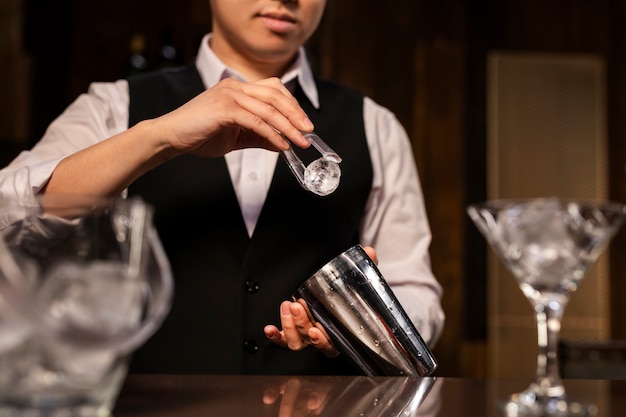 Front view bartender preparing drink