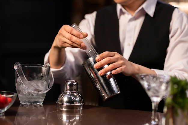 Front view bartender preparing drink