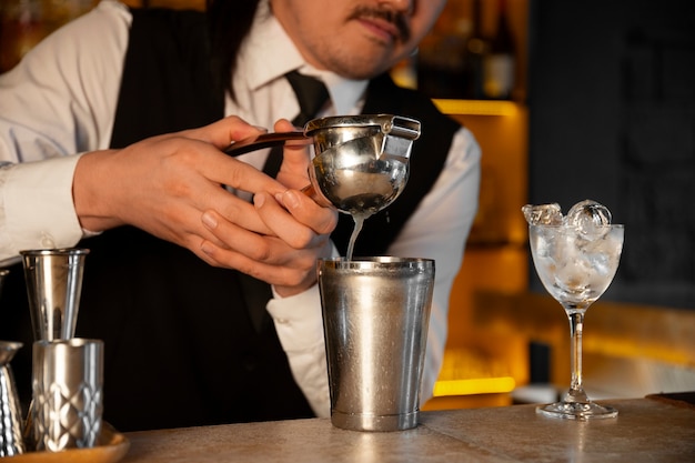 Front view bartender preparing drink