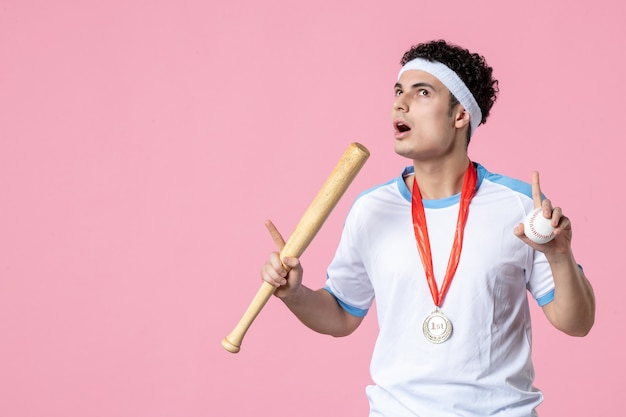 Free photo front view baseball player in sport clothes with medal