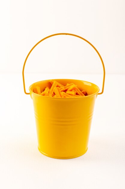 A front view basket with pasta dry italian orange pasta inside yellow basket on the white