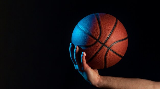 Front view of basketball held by male hand