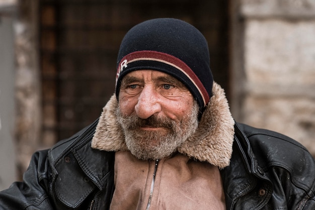 Front view of bearded homeless man outdoors