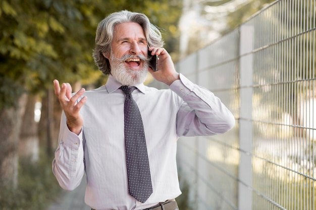 Free photo front view bearded mature male talking on the phone