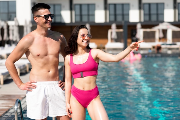 Front view of beautiful couple at pool