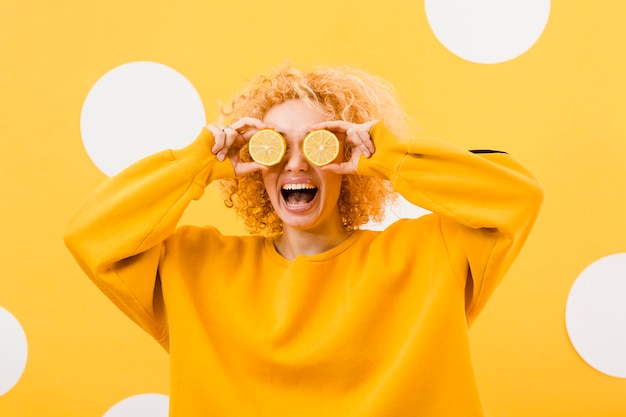 Front view of beautiful girl with lemon slices