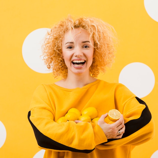 Front view of beautiful girl with lemons