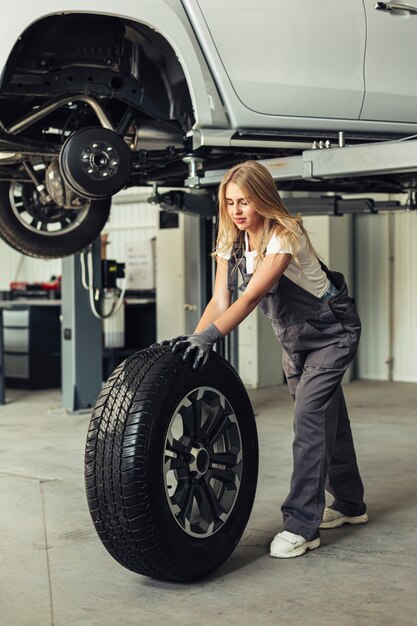 Front view beautiful mechanic woman in shop