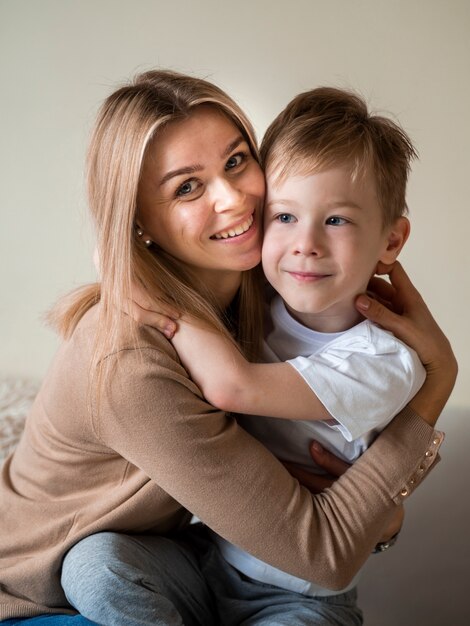 Front view beautiful mother posing with son