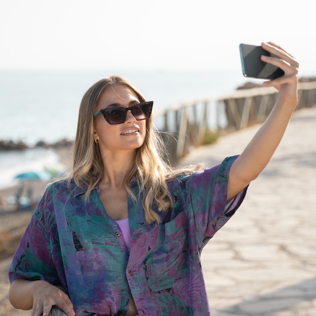 Free photo front view of beautiful woman at beach