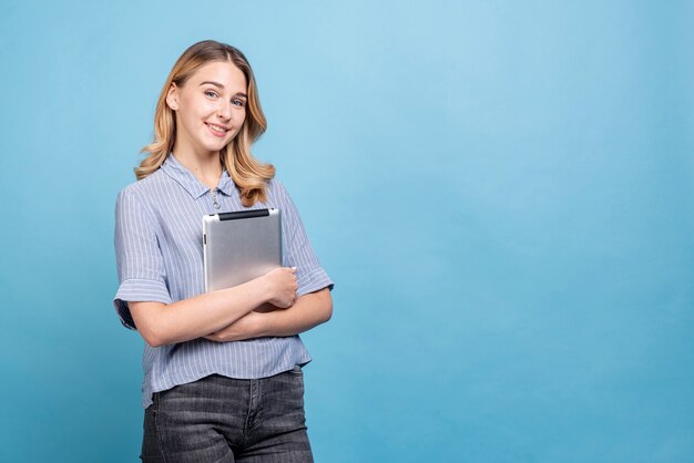 Front view beautiful woman holding a tablet