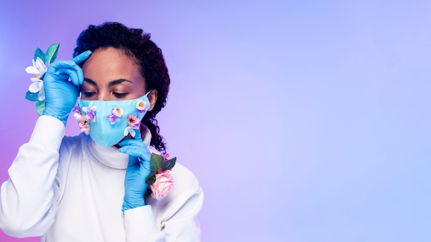 Free photo front view of beautiful woman posing with floral gloves and copy space