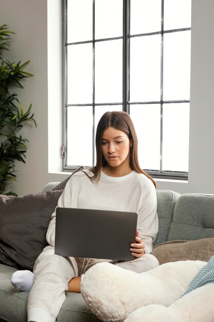 Front view of beautiful woman staying on laptop