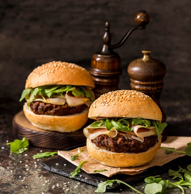 Front view beef burgers with bacon on slate board