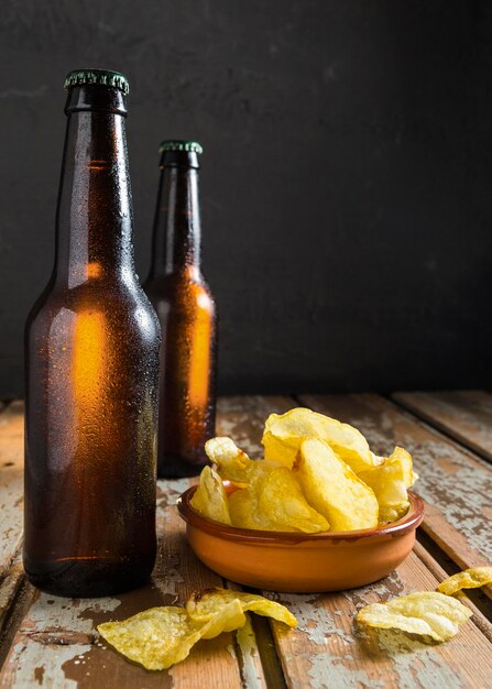 Front view of beer glass bottles with chips