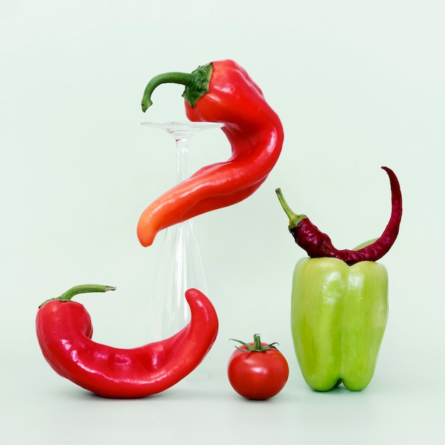 Free photo front view of bell and chili peppers with tomato