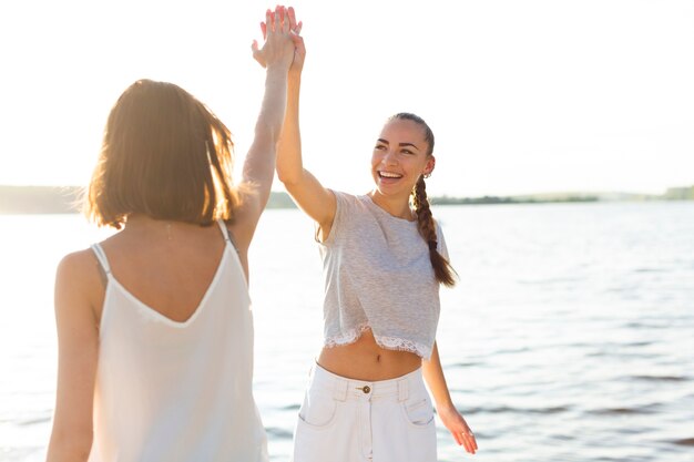 Front view best friends high fiving 