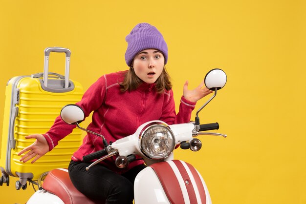 Front view bewildered young girl on moped