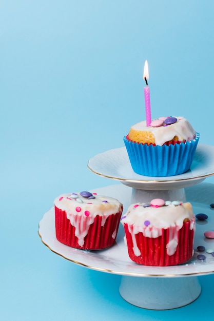 Front view birthday cupcakes arrangement on blue background