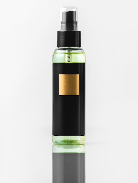 Free photo a front view black bottle black and gold fragrance isolated on the white wall