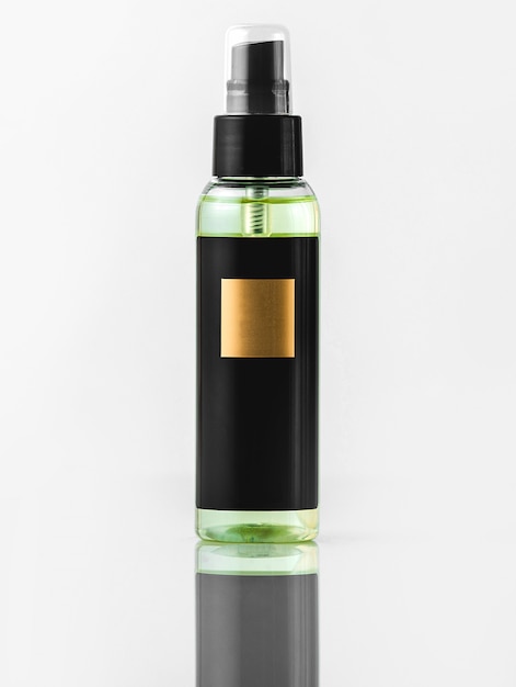 A front view black bottle black and gold fragrance isolated on the white wall