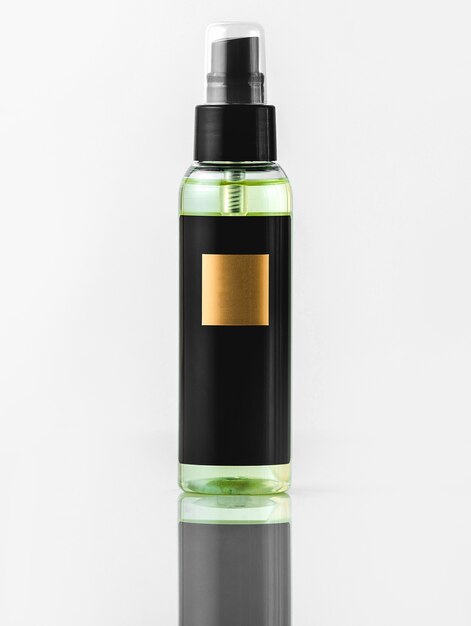 A front view black bottle black and gold fragrance isolated on the white wall