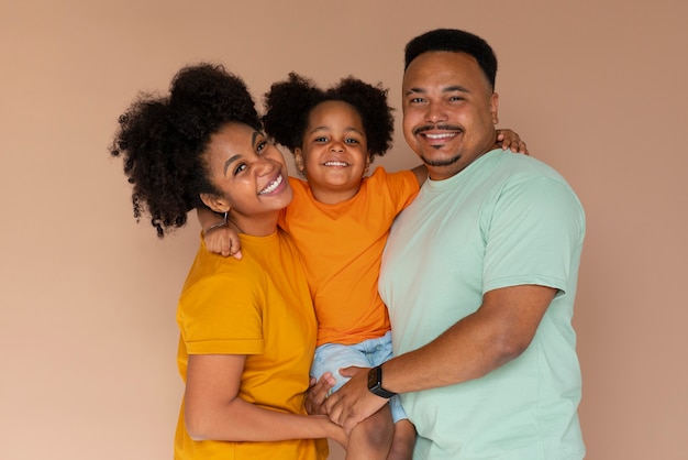 Free photo front view black family posing in studio