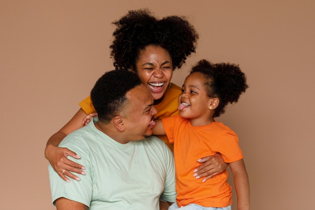 Front view black family posing in studio