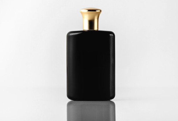 A front view black fragrance designed with gold cap on the white floor