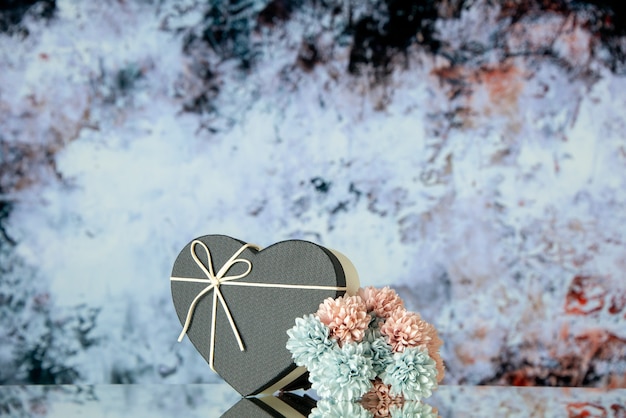 Front view black heart box colored flowers on dark grey abstract background