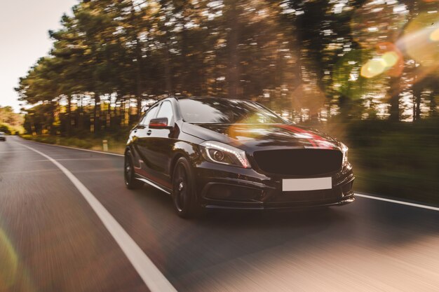 Front view of a black luxury sedan on the road.