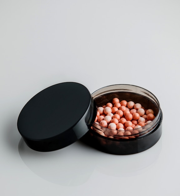 Free photo front view black round powder box with powder in the form of balls