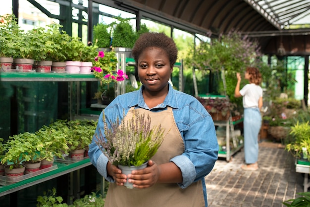 Front view black woman running a flower business