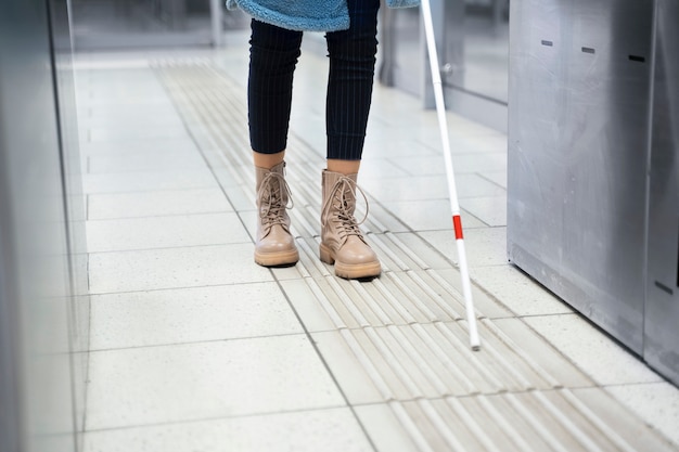 Free photo front view blind person with white cane