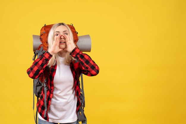 Front view blonde girl with her backpack calling someone