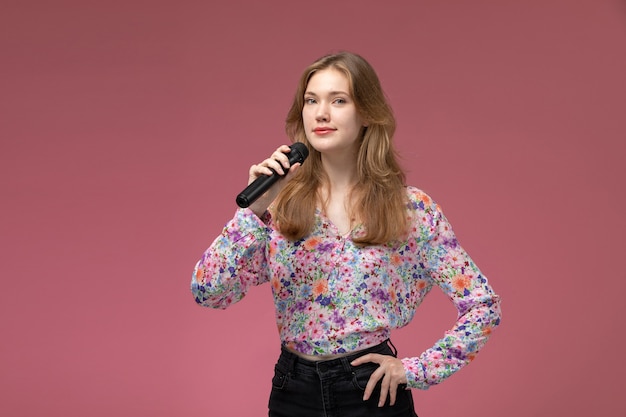 Front view blonde lady using her black microphone