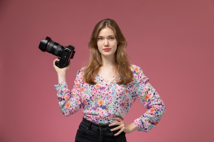 Free Photo front view blonde lady with her photocamera on her right hand