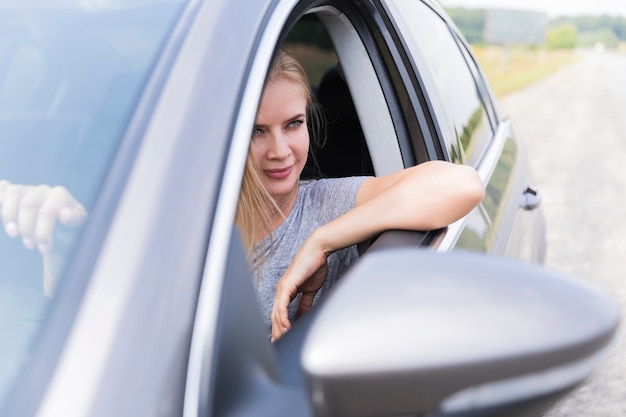 Front view of blonde woman driving