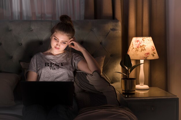 Front view of blonde woman at laptop