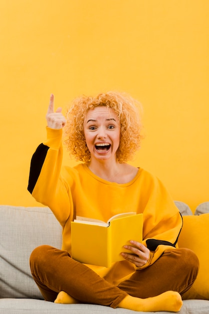 Front view of blonde woman with book