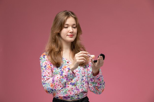 Front view blonde woman with cosmetic powder brush