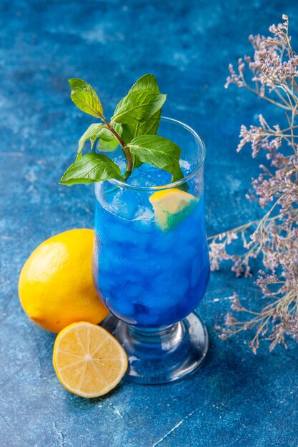 Front view blue cool lemonade with ice on the blue background fruit water cold cocktail drink color bar juice