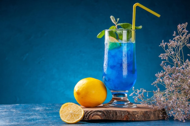 Front view blue cool lemonade with ice on blue background fruit water cold cocktail drink color juice