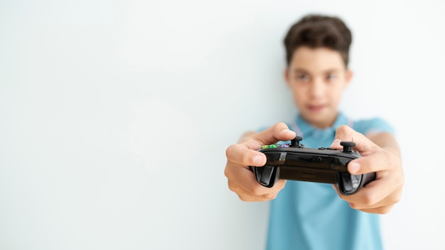Front view blurred kid holding a controller